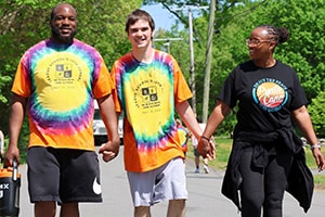 League School staff walking with a student. 