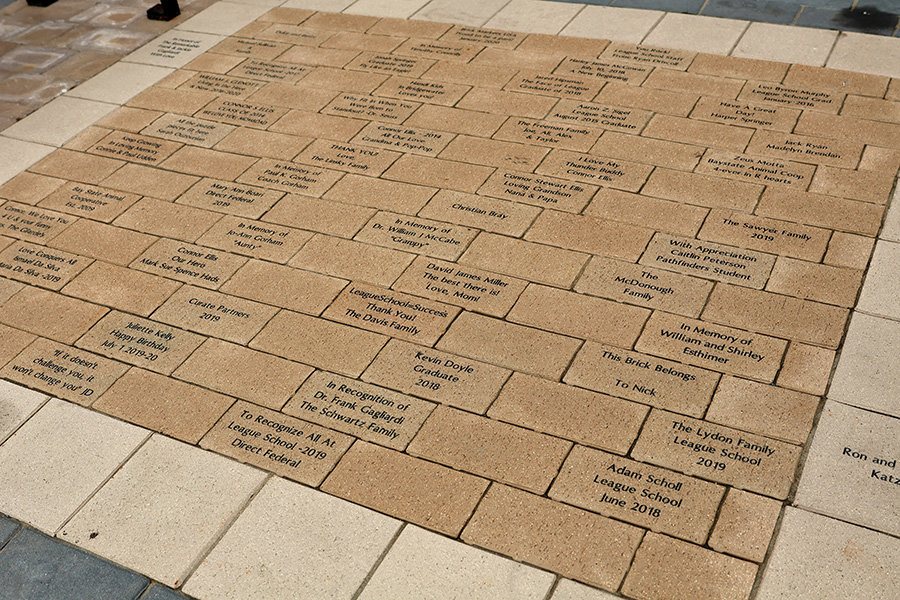 Selection of bricks purchased and installed on League School grounds.